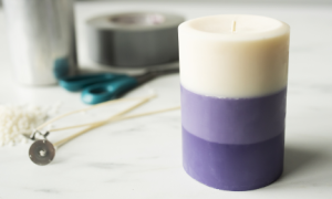 A layered candle made with a candle making kit, showcasing the technique to create smooth color transitions.
